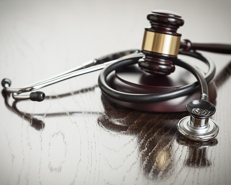 Stethascope set with legal hammer representing Medical malpractice insurance
